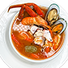 Bowl of Caldo 7 Mares, a rich Mexican seafood soup with shrimp, fish, octopus, crab, and mussels.